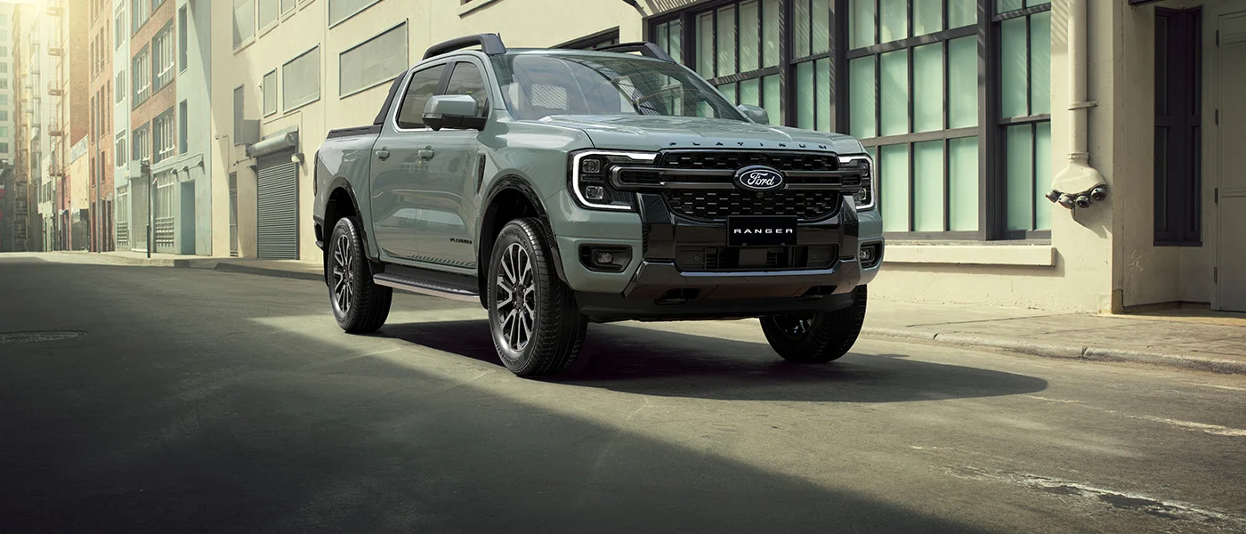 A grey Ford Ranger Platinum parked on a city street in sharp light